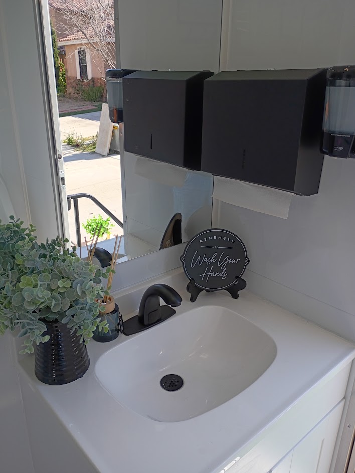Vanity with fresh florals inside the luxury lavatory suite